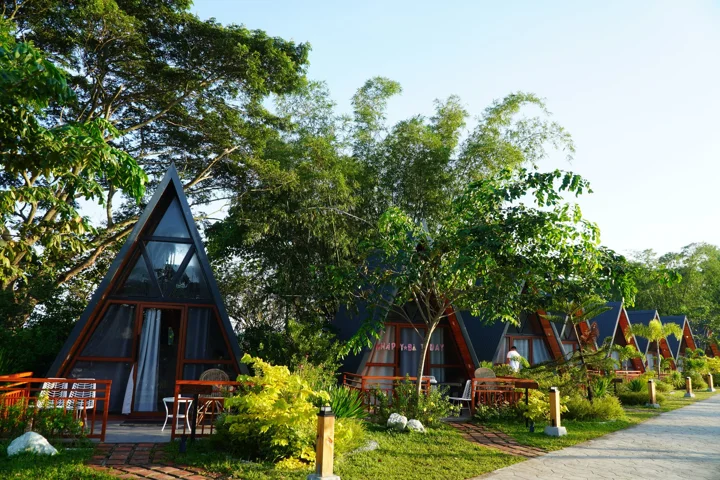 A-frame cabins nestled among the farmhouse gardens