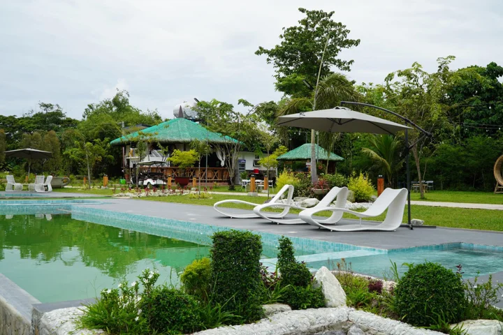 Poolside seating and rustic pavilion